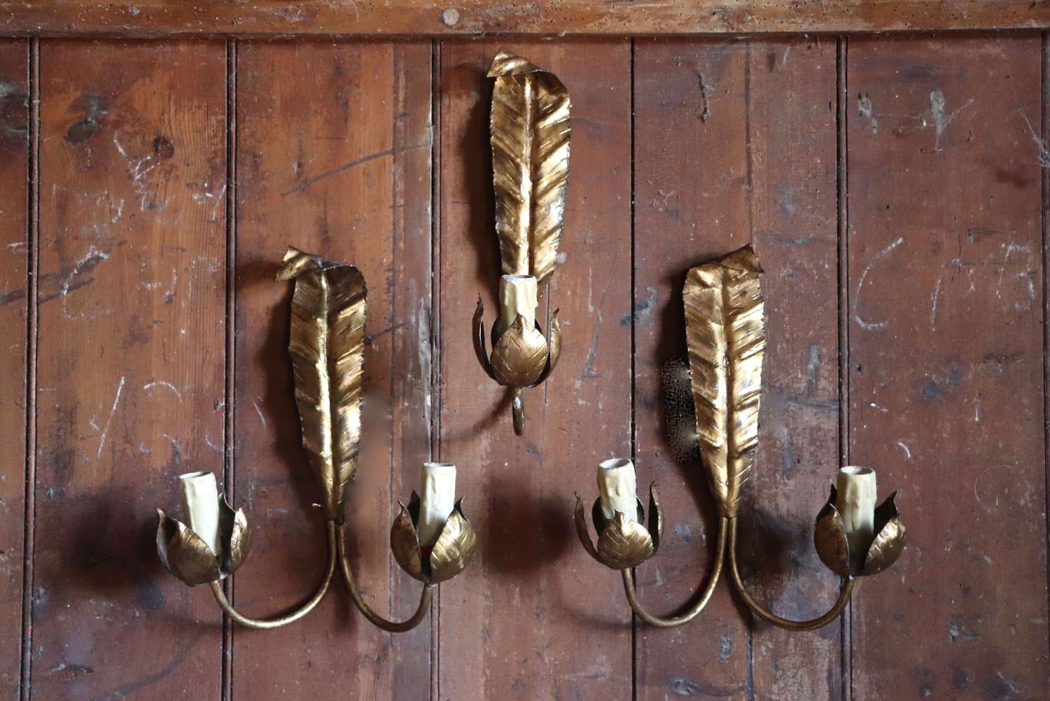 Pair of mid century gilt leaf wall sconces and a single