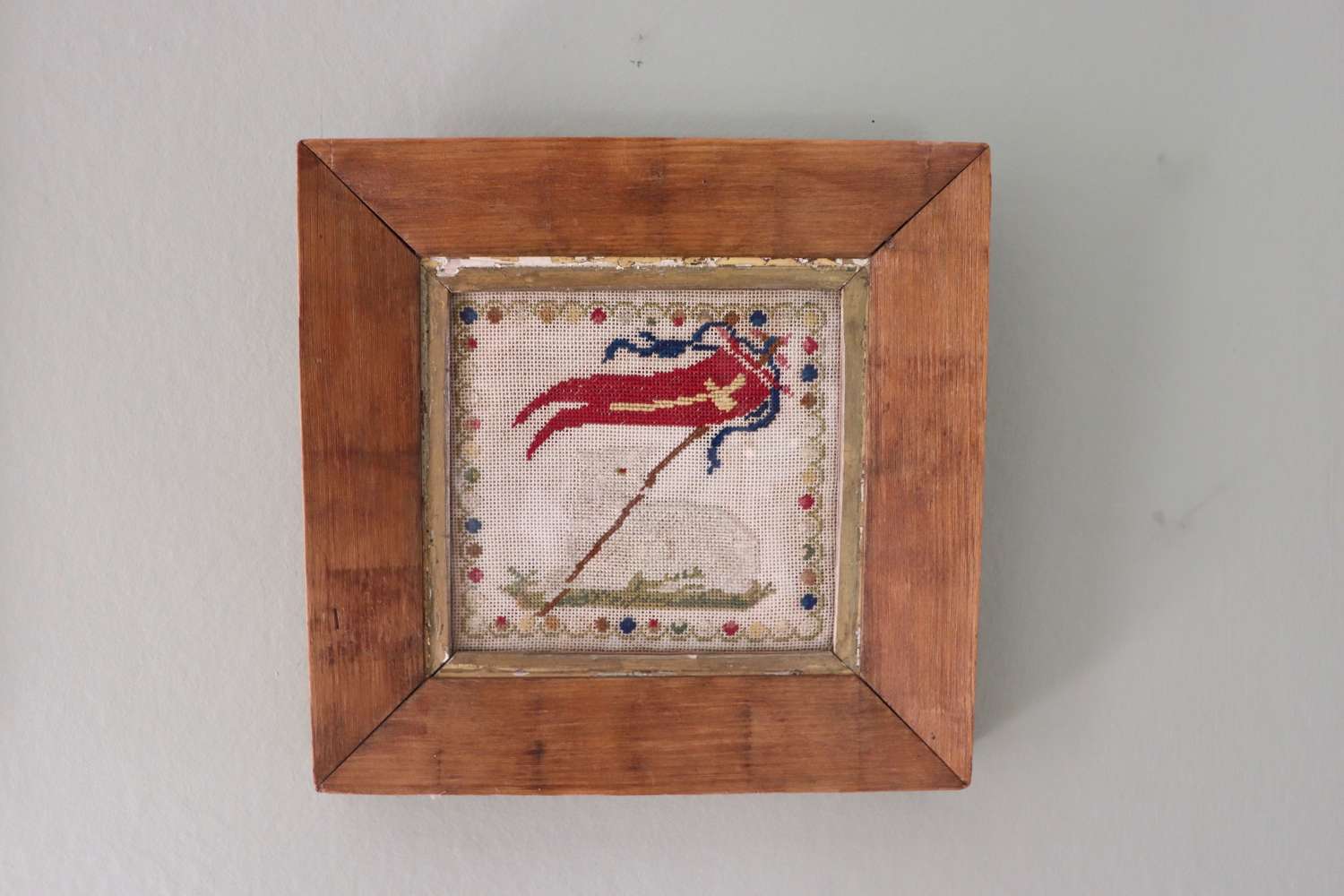 19th century needlepoint of lamb and flag in pine frame