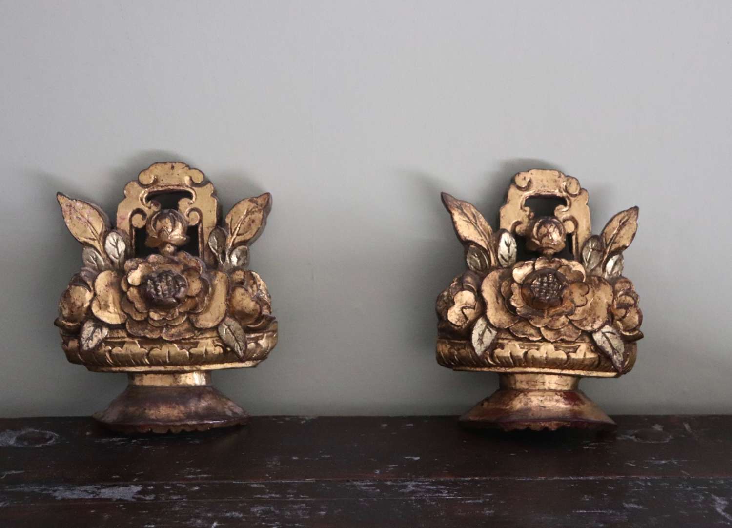 Pair of 19th century gilt wooden carvings depicting flowers in an urn