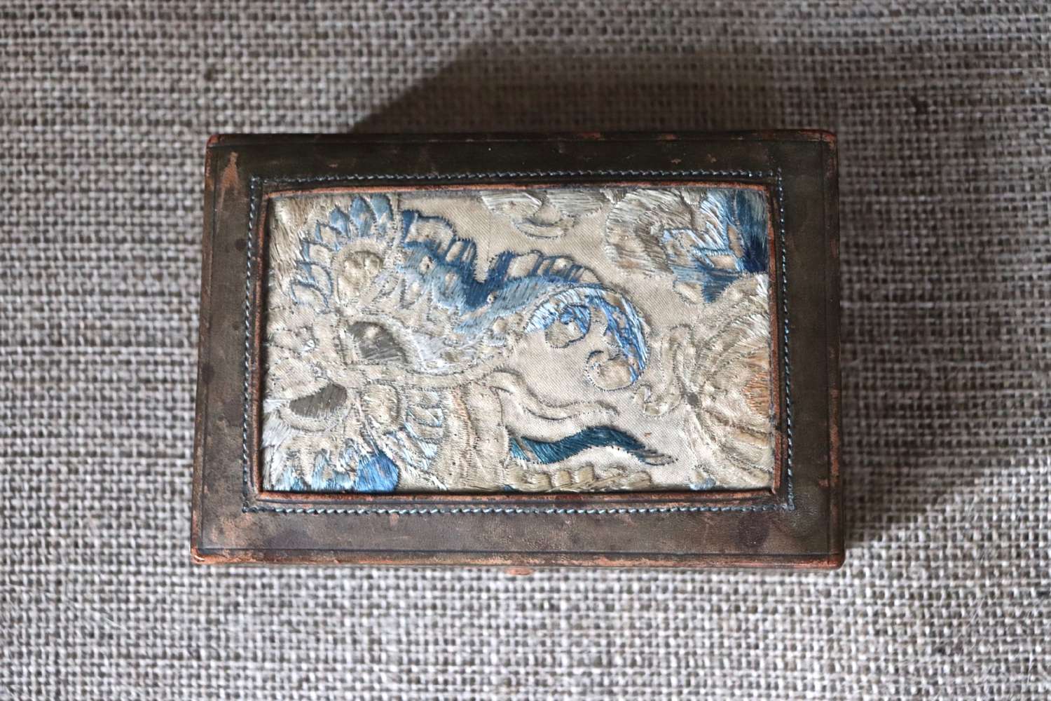 Early 20th century leather box with oriental fabric