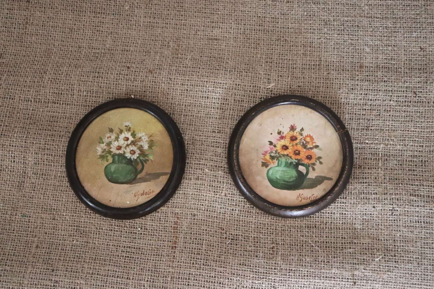 Pair of signed floral pictures in circular frames