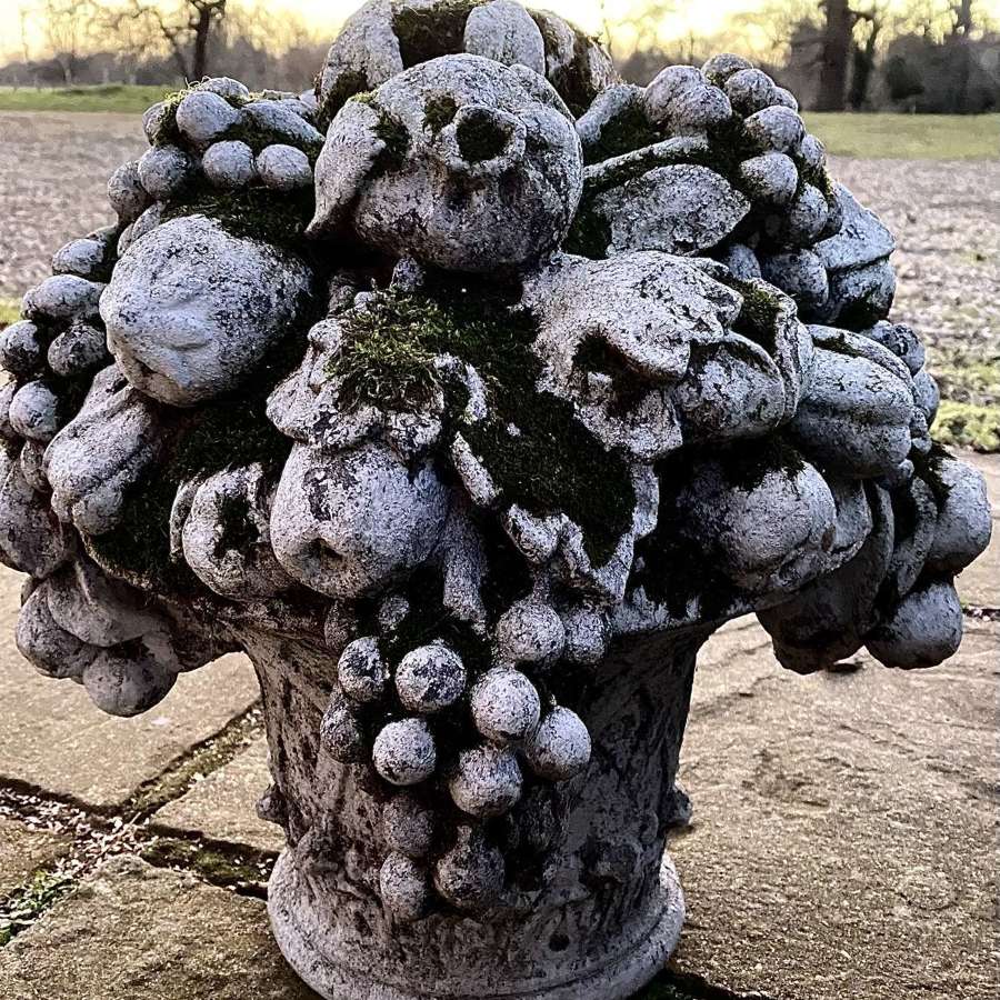 Reconstituted stone flowers in urn