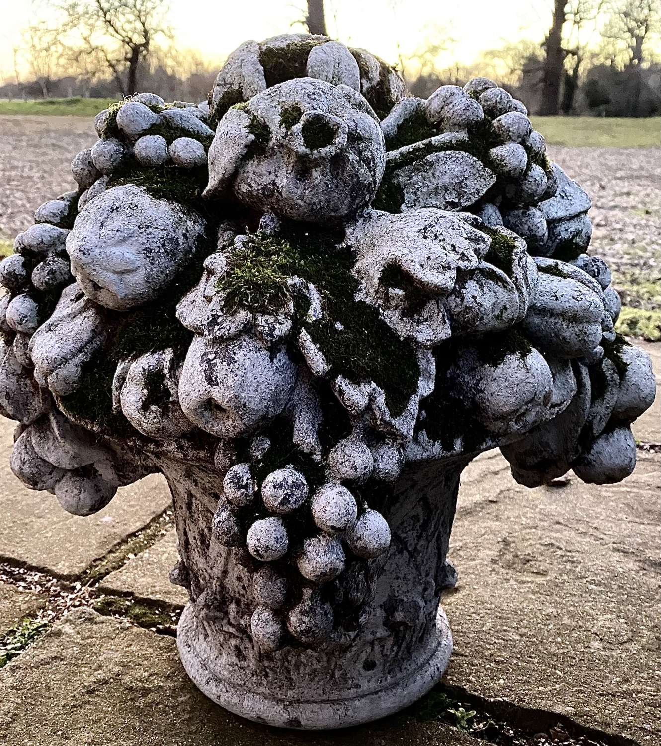 Reconstituted stone flowers in urn